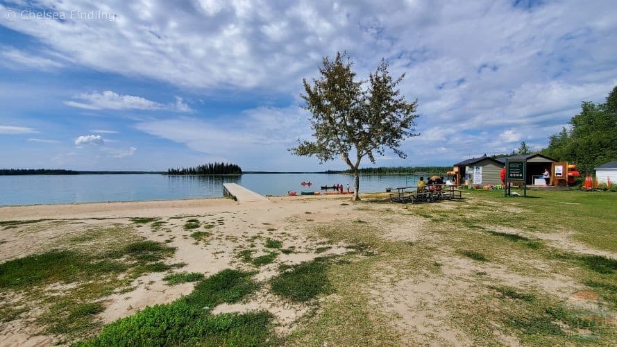 Dock with rental equipment on calm waters at Astotin Lake in Elk Island National Park, Alberta. 