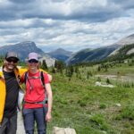 6 Romantic Outdoor Adventures near Rocky Mountain House include a couple standing in front of mountains.