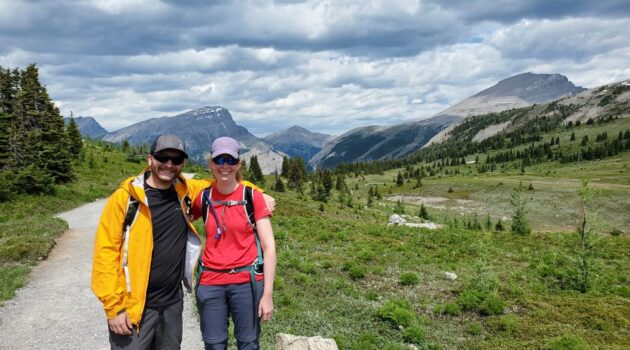 6 Romantic Outdoor Adventures near Rocky Mountain House include a couple standing in front of mountains.