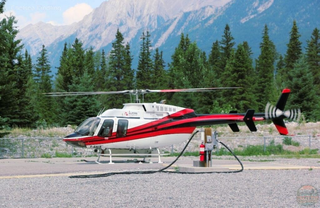 Couple about to enjoy a helicopter tour over the Canadian Rockies.