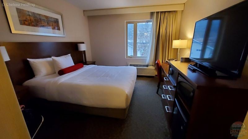 Interior of a Crimson Hotel room with modern decor and a comfortable bed.