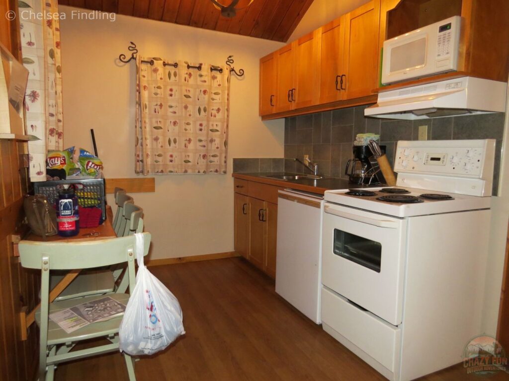 Cozy Bear Hill Lodge suite with kitchenette and fireplace, ideal for a romantic stay after a day on Marmot slopes.