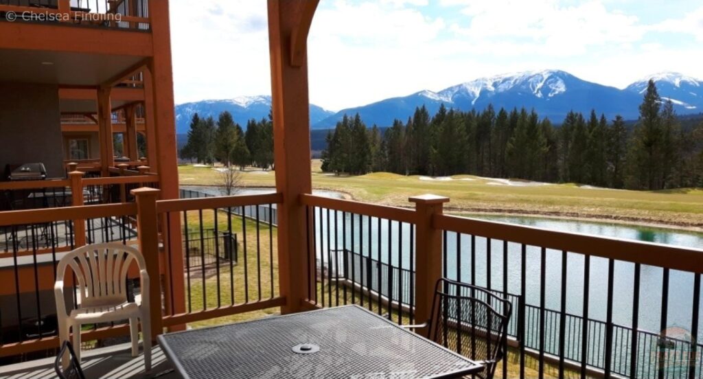 Looking out at mountain scenery from a deck at Bighorn Meadows Resort, with surrounding peaks and natural landscape visible in the distance in the Canadian Rockies. 