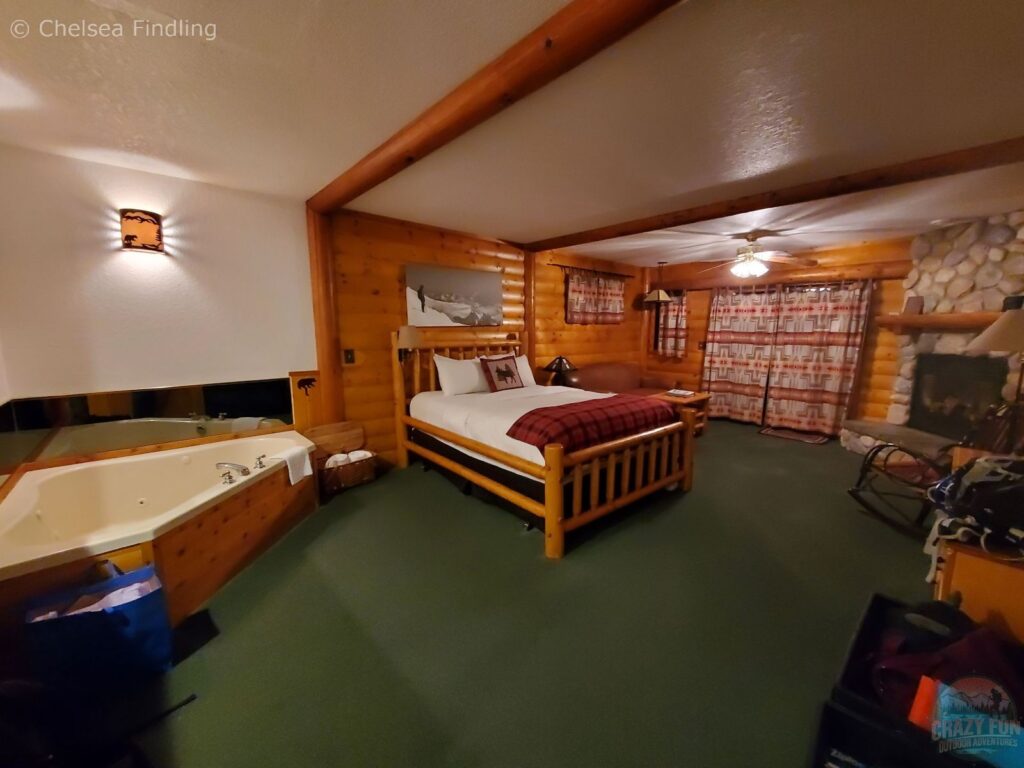Inside a guest room at Baker Creek Mountain Resort with a jacuzzi, bedroom furnishings, and cozy mountain lodge interior.