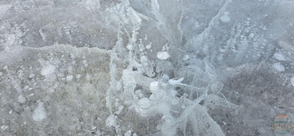 Rocks seen below the cloudy ice. 