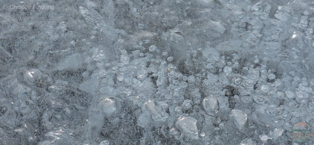 Cloudy bubbles below Abraham Lake surface. 