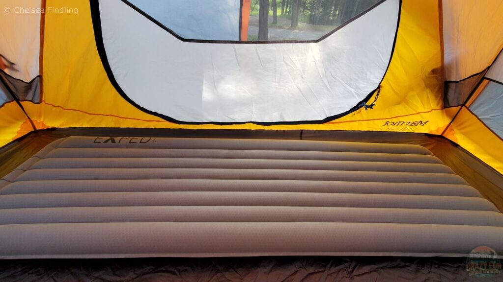 An Exped sleeping mattress on the floor of a tent. 